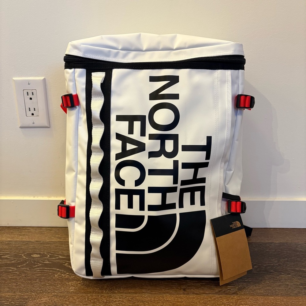 The North Face White Backpack with Black Logo and Red Accents